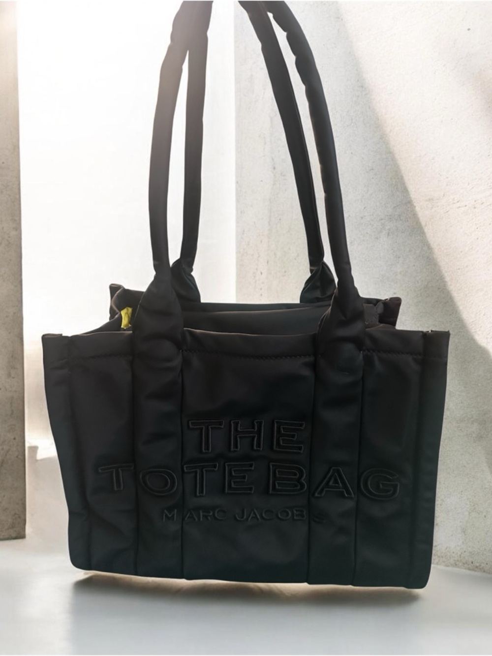 This is a Marc Jacobs The Puffy Nylon Medium Tote Bag.